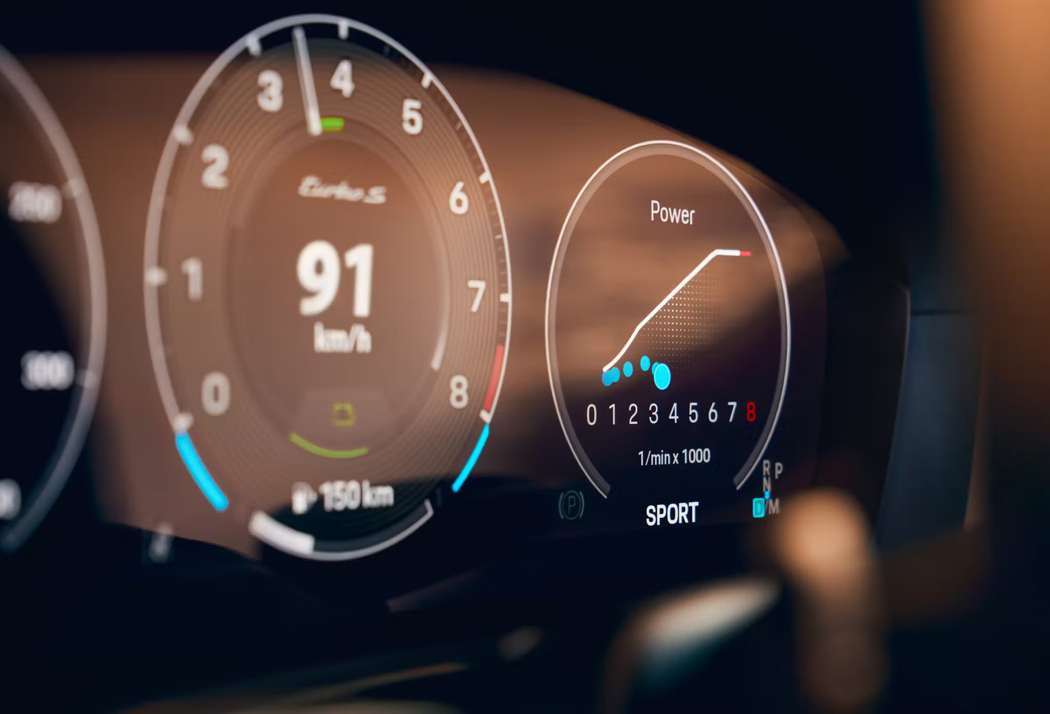 2026 Porsche 911 Turbo S driving on road symbolizing performance and fuel efficiency.