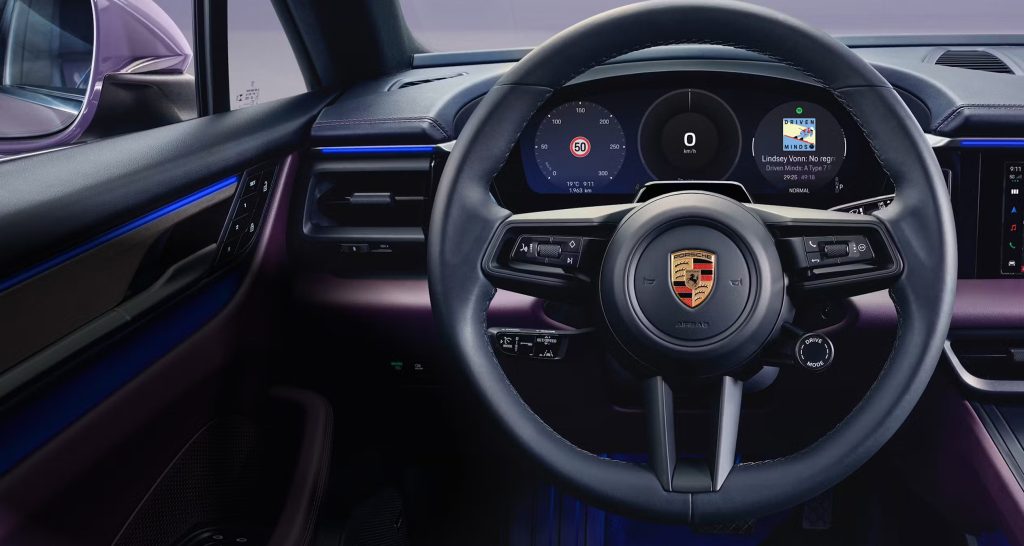 Porsche Macan EV driving on a curvy road demonstrating advanced handling dynamics.