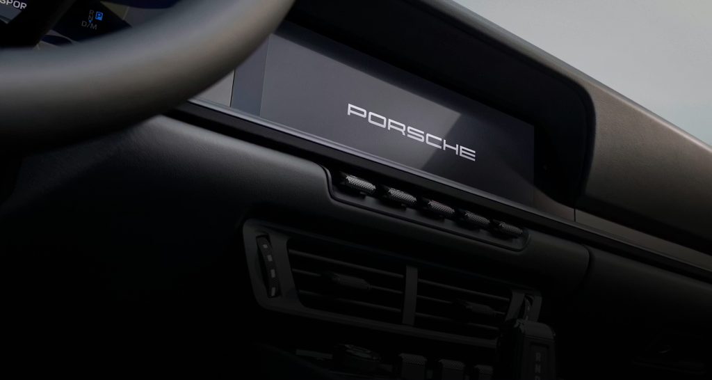 Porsche 911 dashboard screen with Porsche branding, showing the mix of modern technology that helps the Porsche 911 define the modern sports car.