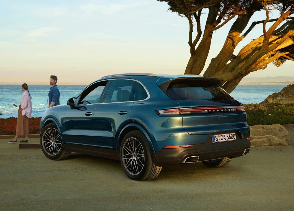 Porsche Cayenne parked by the coast at sunset, representing how the Porsche Cayenne continues to define the luxury performance SUV with style and efficiency.