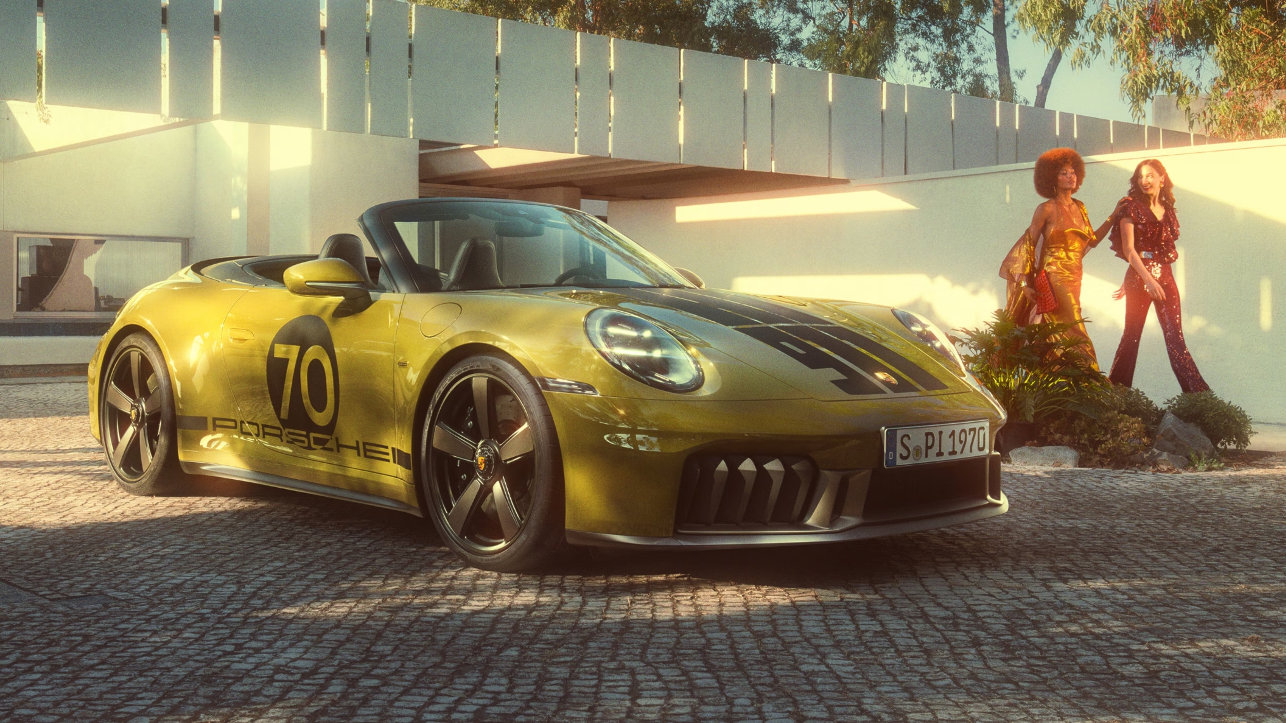 Gold 2026 Porsche 911 parked outside a modern home, showcasing the hybrid performance and iconic design of the legendary sports car.
