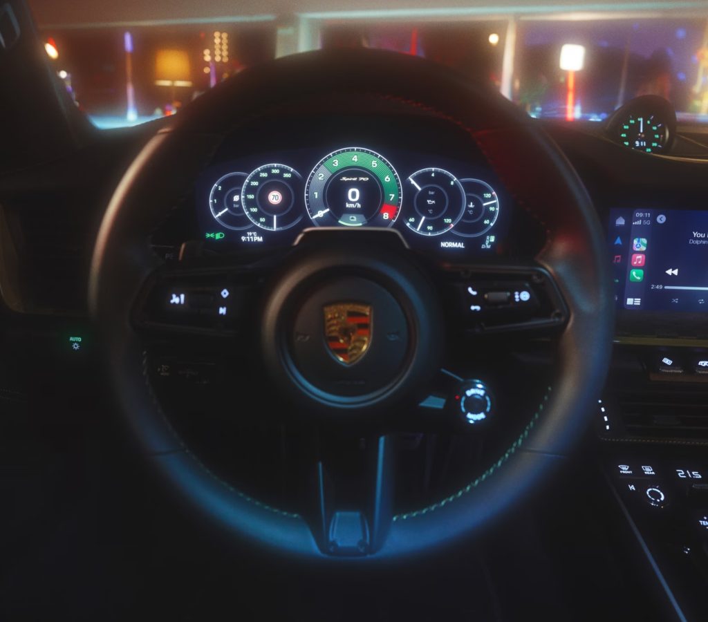 Interior view of the 2026 Porsche 911 dashboard and digital display, showing updated Porsche Communication Management technology in the hybrid performance sports car.