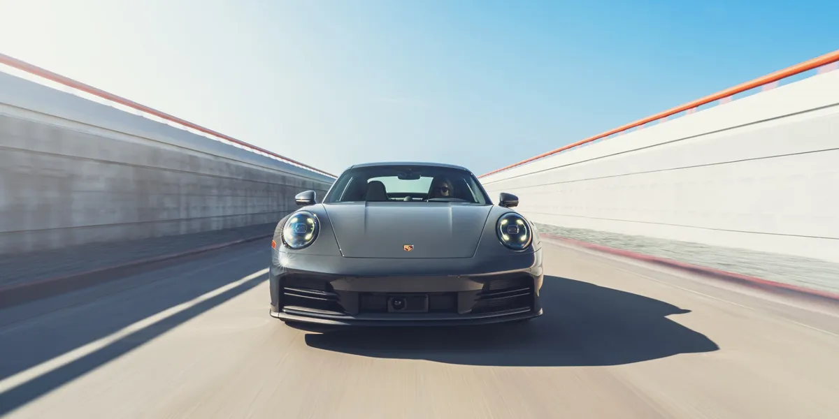 2026 Porsche 911 Carrera front driving view through high-speed urban tunnel
