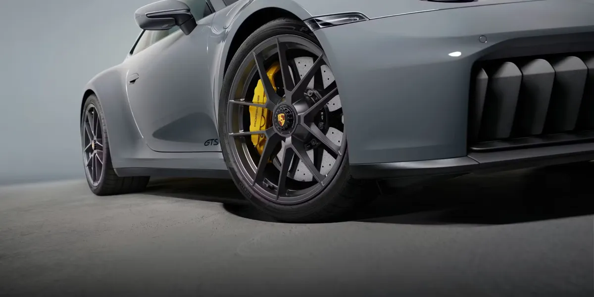 Rear view of blue 2026 Porsche 911 Carrera showcasing signature lightbar and license plate.