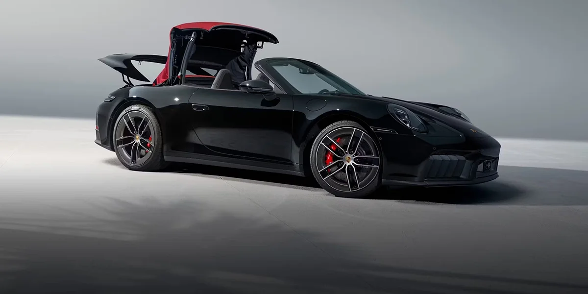 2026 Porsche 911 Carrera 4S Cabriolet driving along the Pacific Coast Highway with top down, illustrating open-air performance and refined driving experience.