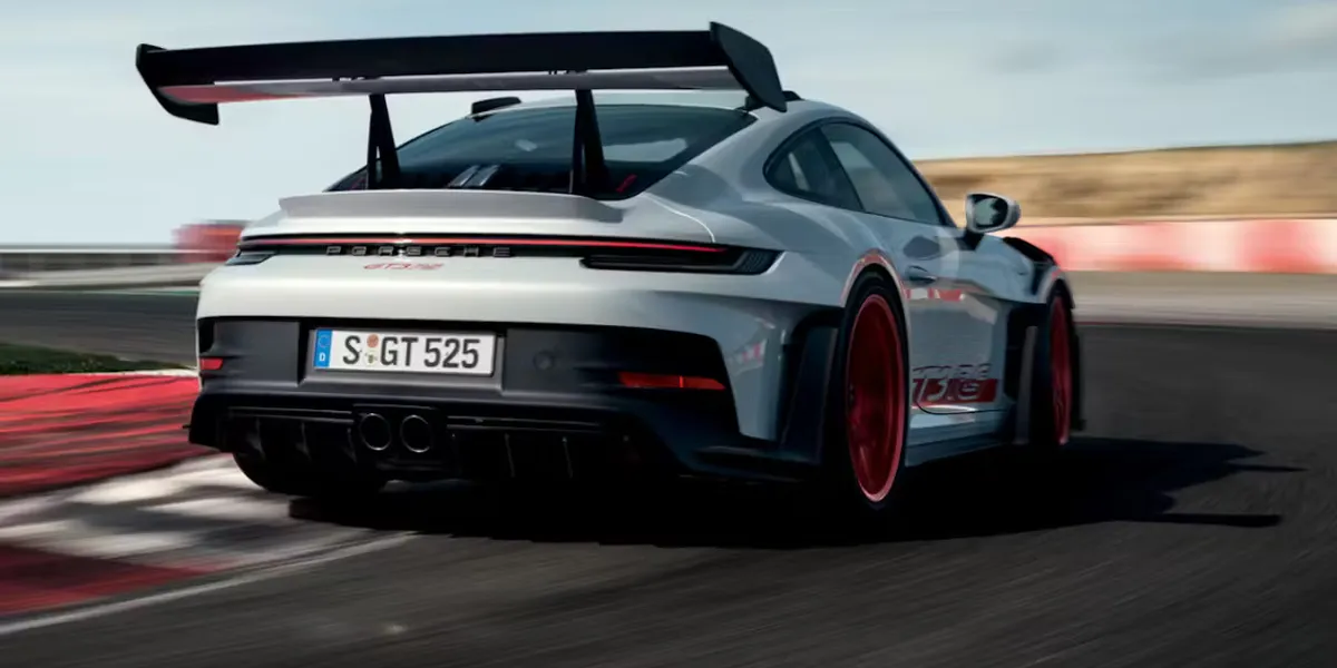 Close-up of 2026 Porsche 911 Carrera GTS front wheel with yellow calipers and PASM system.