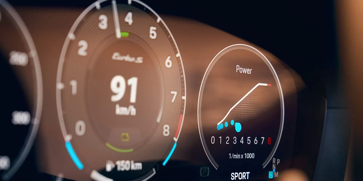 Digital instrument cluster of the 2026 Porsche 911 Turbo S showing tachometer, power gauge, and sport mode.