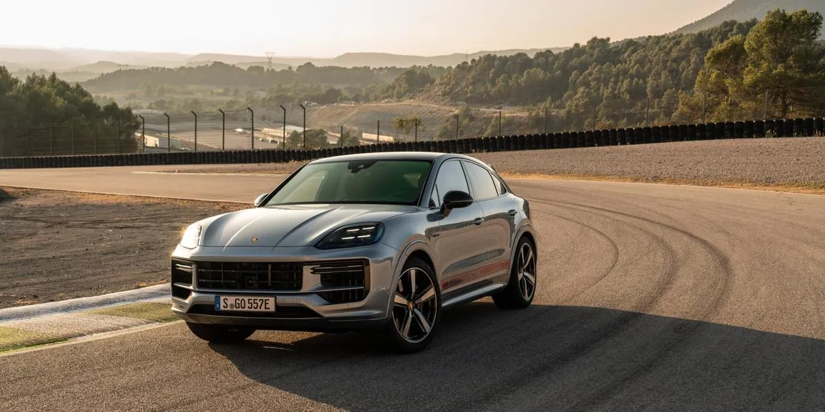 2026 Porsche Cayenne parked on a racetrack at sunset