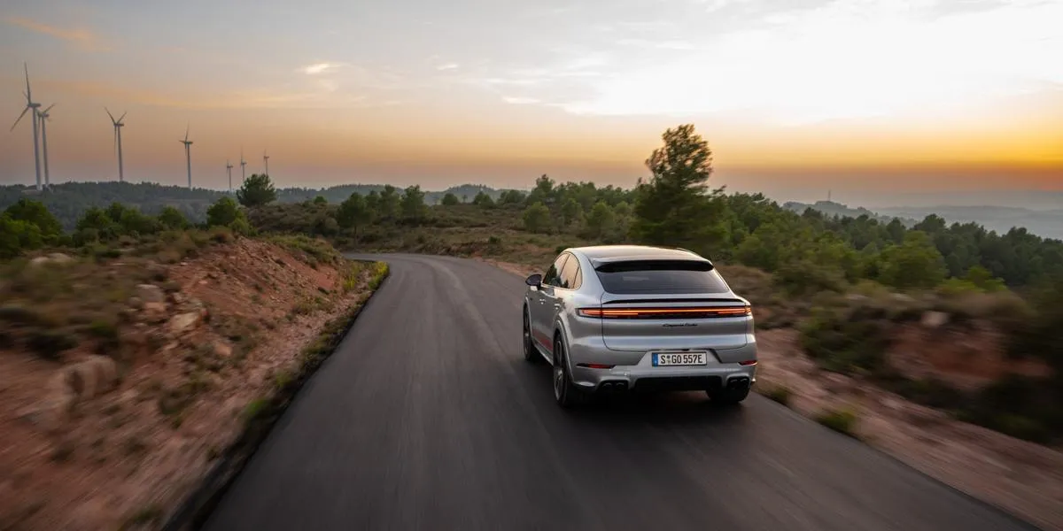 2026 Porsche Cayenne driving on a scenic mountain road