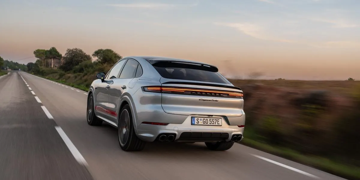 2026 Porsche Cayenne driving on an open road at dusk