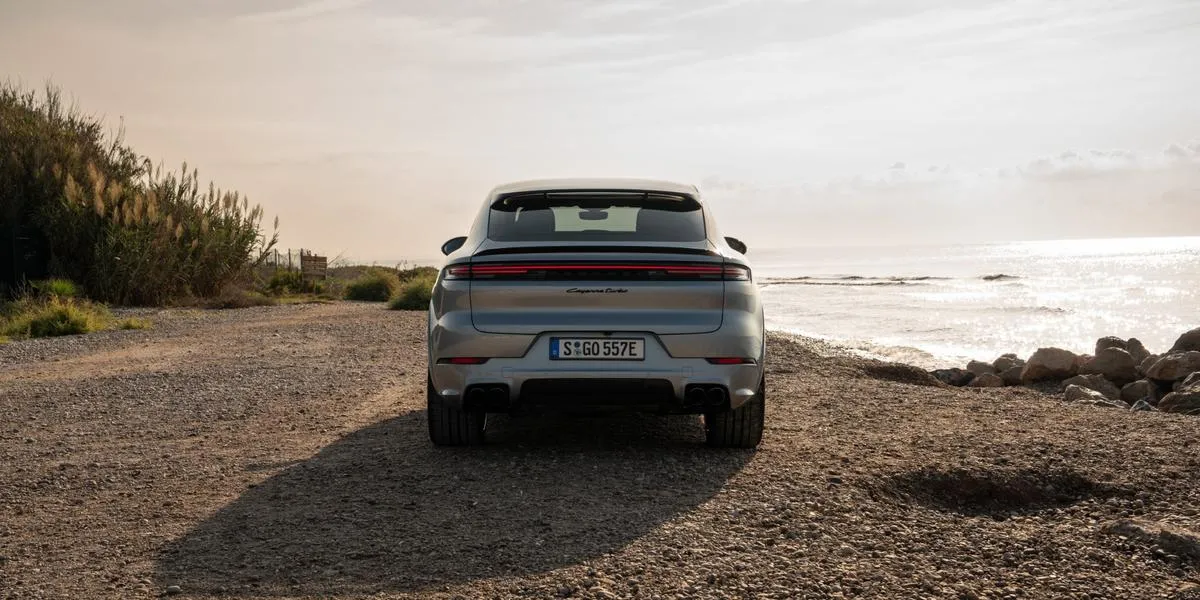 Rear view of the 2026 Porsche Cayenne parked near a beach