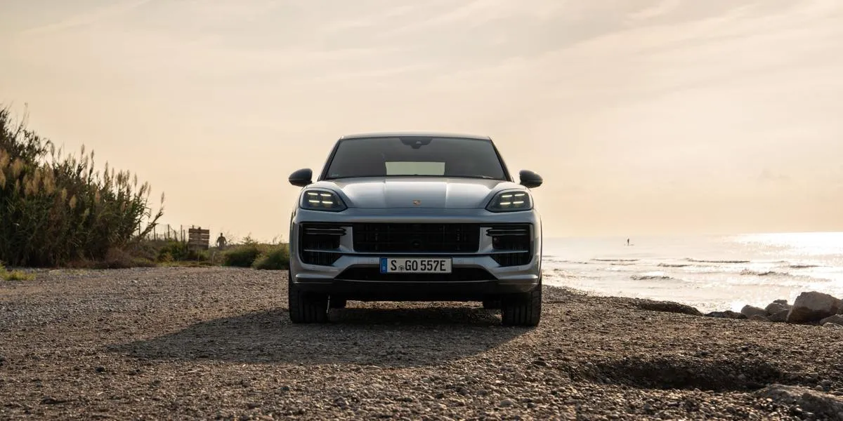 Front view of the 2026 Porsche Cayenne on a rocky coastal area