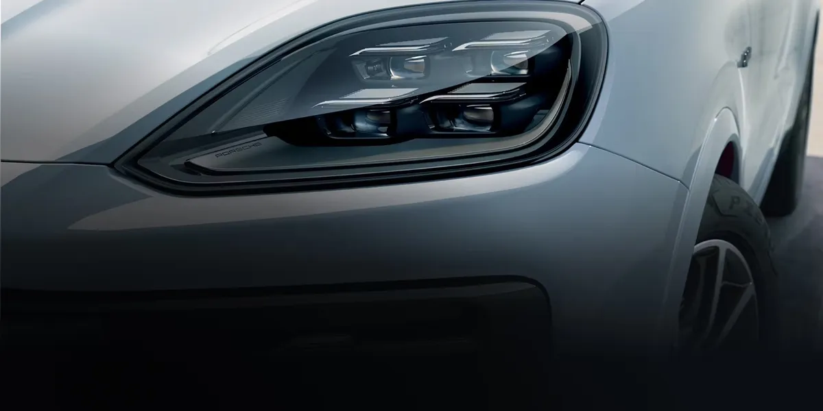 Close-up of the 2026 Porsche Cayenne front wheel with black alloy rim and performance-tuned suspension.