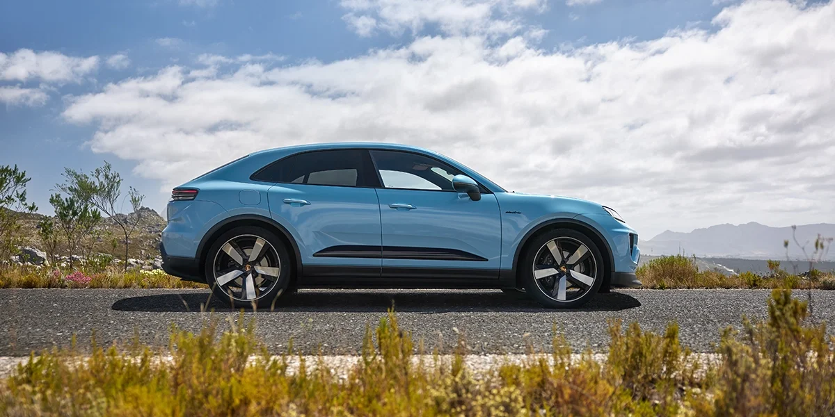Top-down shot of Porsche Macan T driving on a winding mountain road