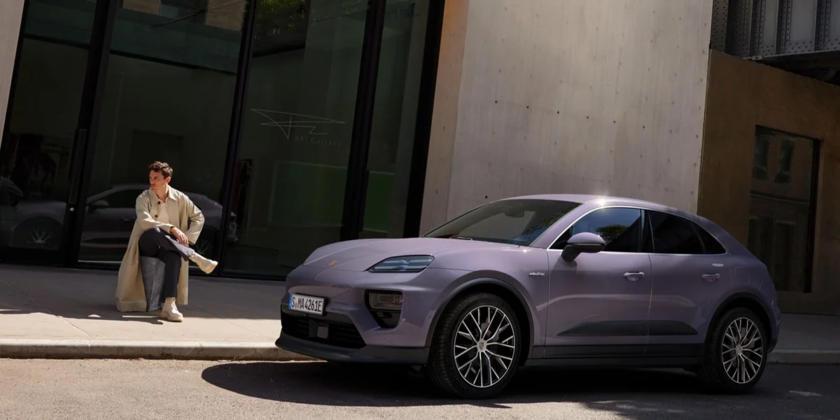 2026 Porsche Macan Electric 4 parked on city street near art gallery