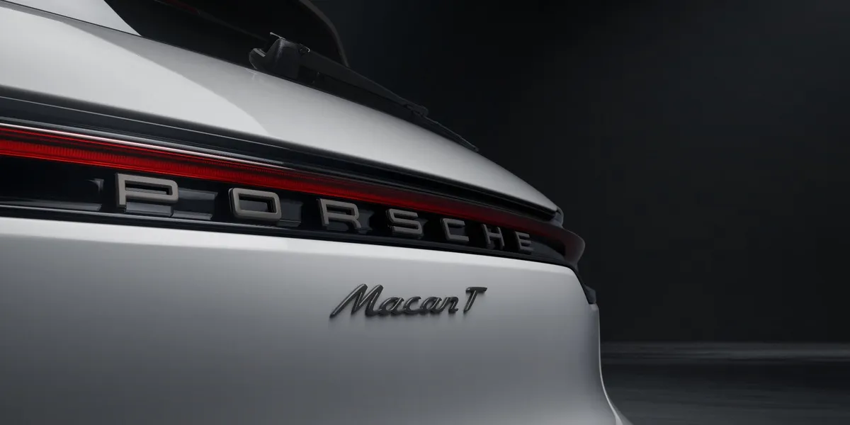Rear view of Porsche Macan T highlighting Porsche logo and taillight bar
