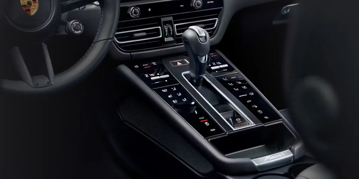 Close-up of Porsche Macan T center console showing gear shifter and control buttons