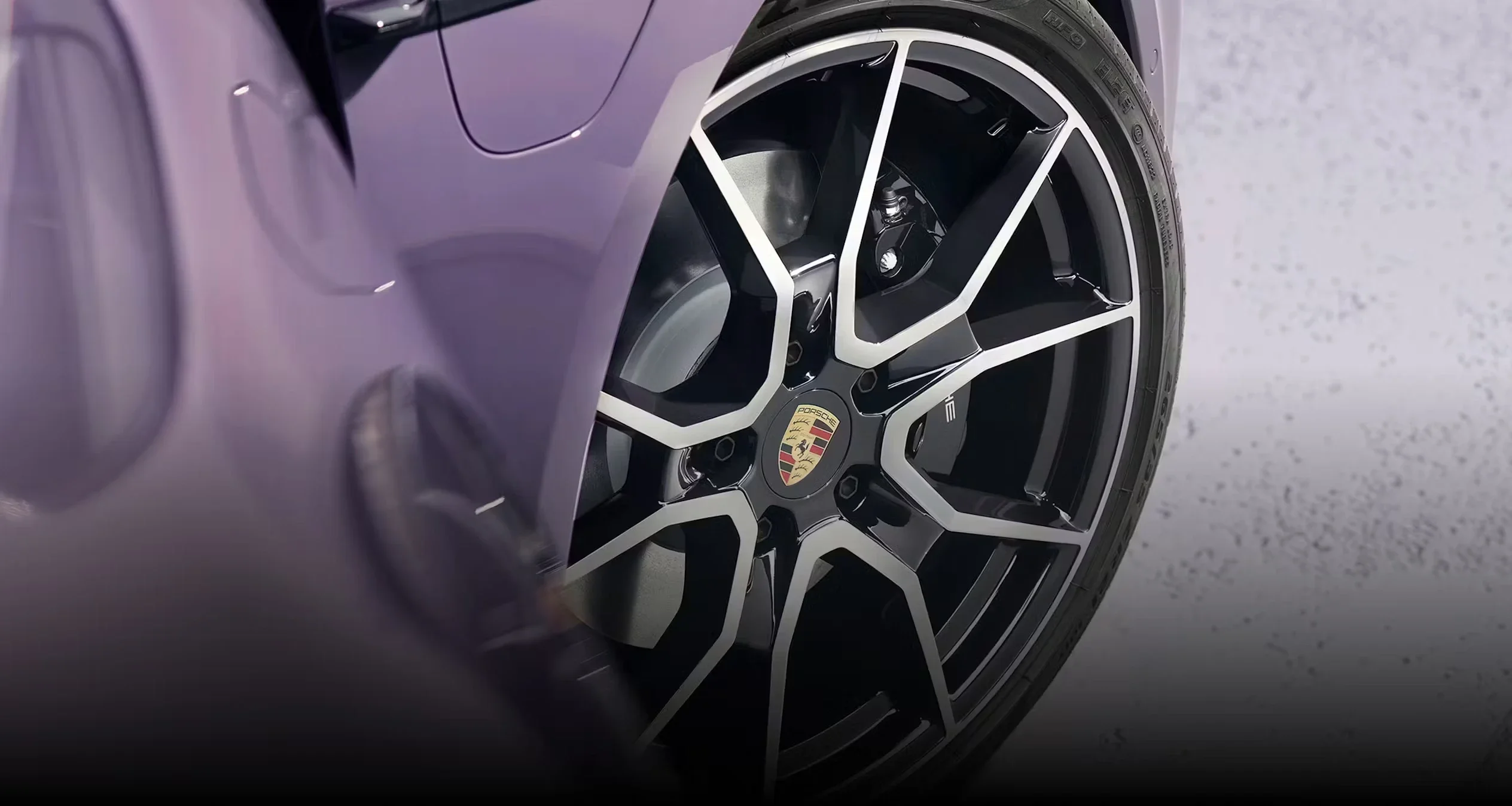 Rear three-quarter top view of Porsche Taycan Cross Turismo in Frozen Berry Metallic emphasizing panoramic roof and sporty wagon profile.