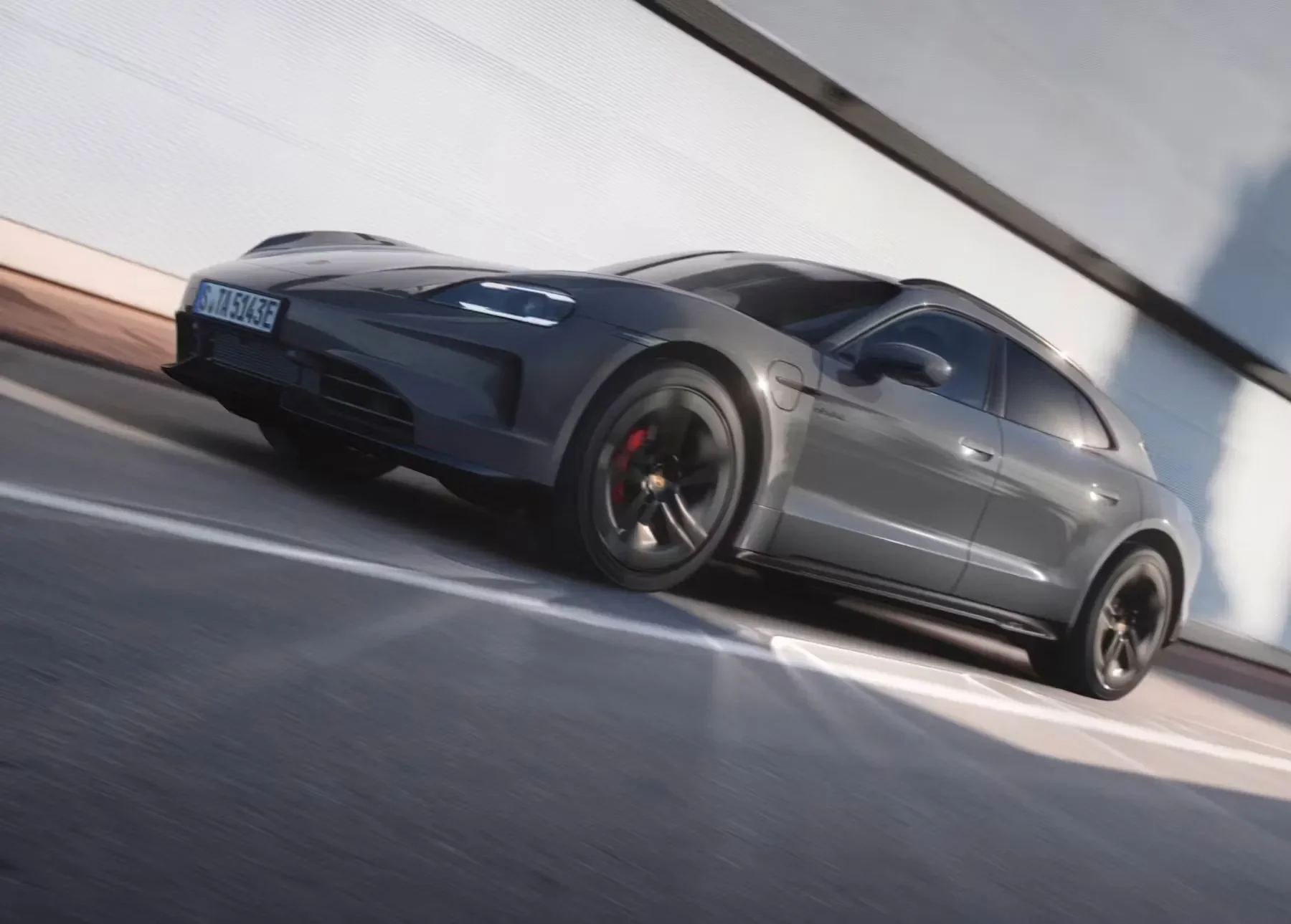 Overhead view of Porsche Taycan Cross Turismo panoramic glass roof revealing cabin layout and sculpted aerodynamic body.