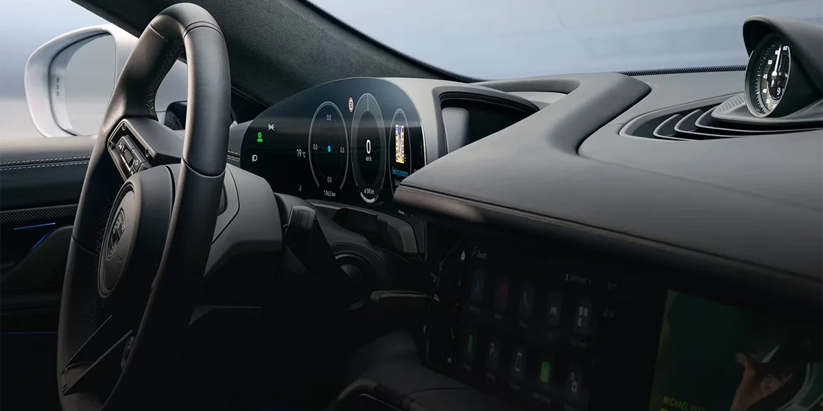 Porsche Taycan charging at a Porsche dealership station, emphasizing EV rapid charging capability.