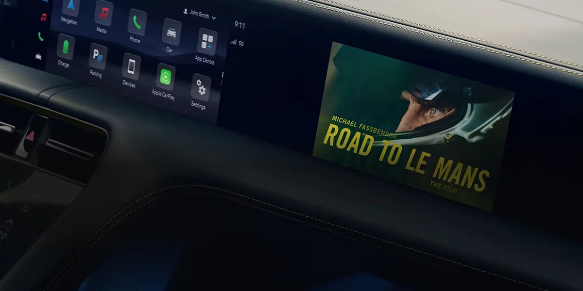 Porsche Taycan interior showcasing digital displays, multifunction steering wheel, and advanced infotainment system.