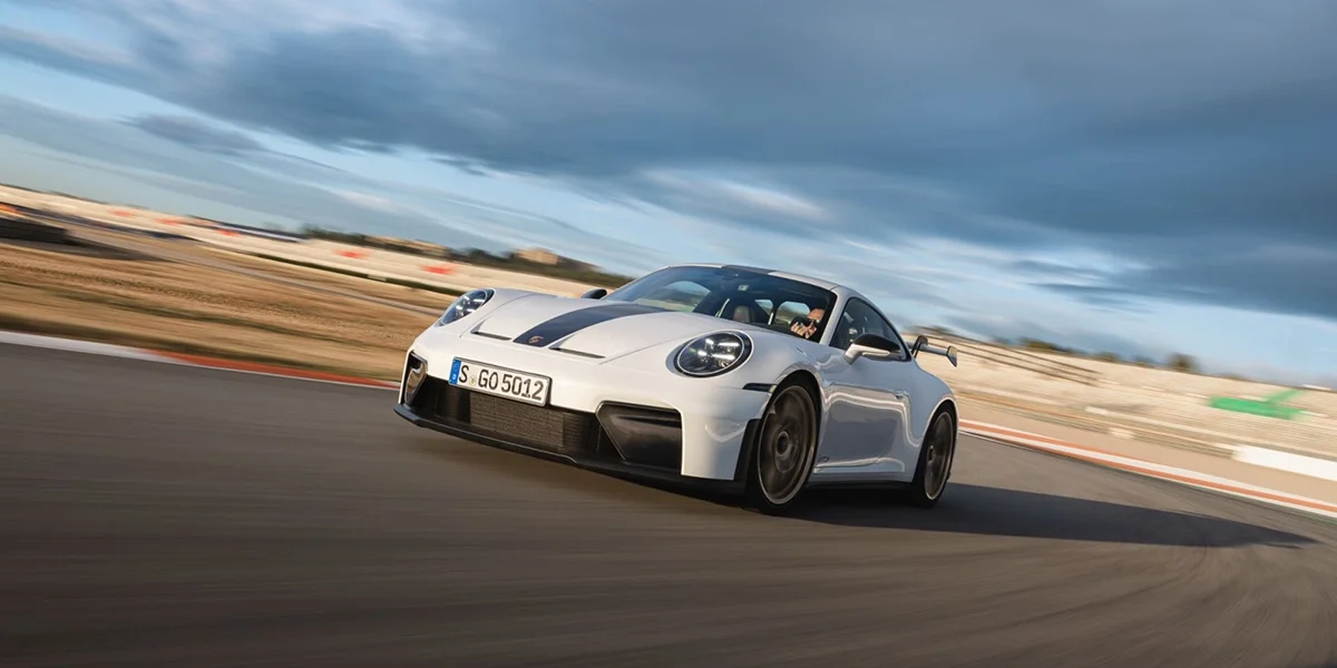 Rear three-quarter view of Porsche 911 GT3 showcasing large rear wing and taillights.