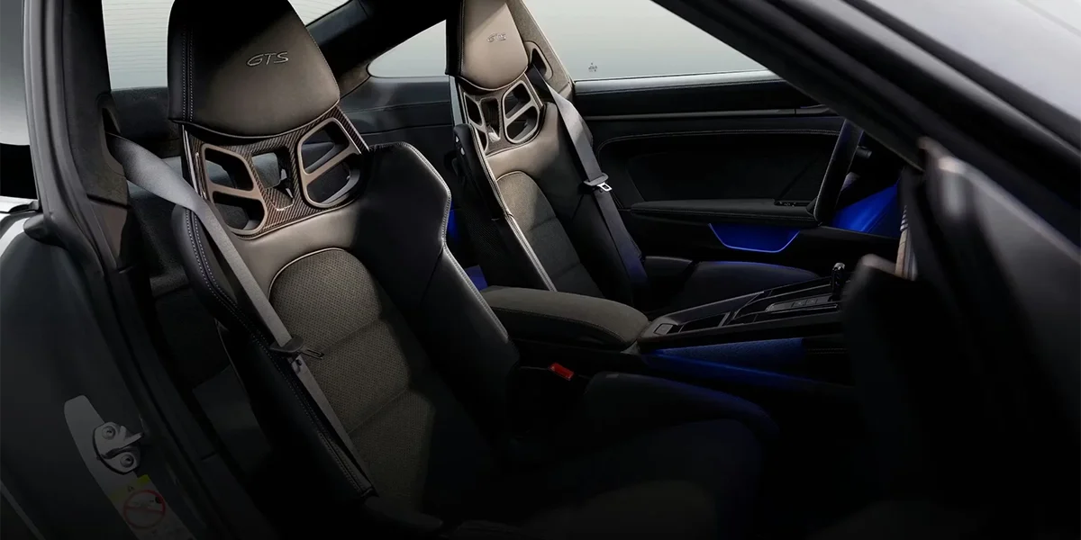 Porsche 911 interior showing a modern dashboard display with traditional Porsche styling.