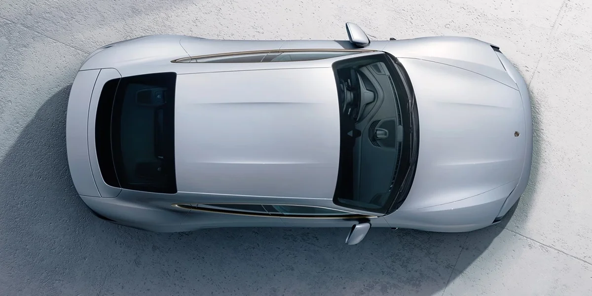 Porsche Taycan viewed from above, showing streamlined roofline and body shape.