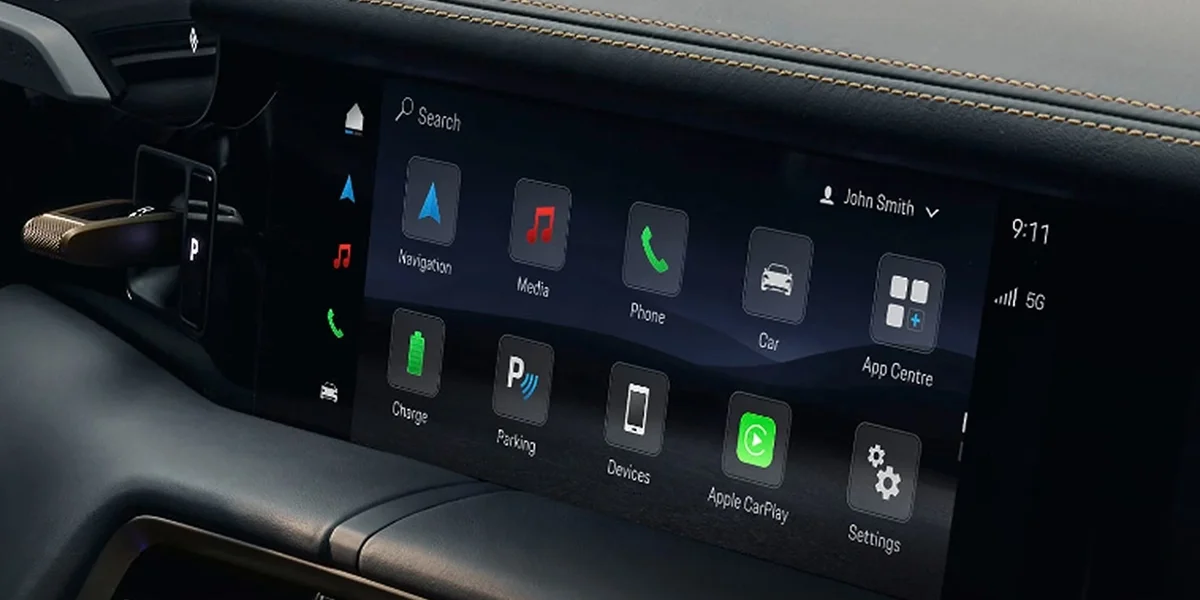 Porsche Taycan dashboard infotainment display with navigation and app icons.