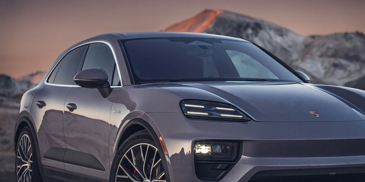 Close-up front view of the 2024 Porsche Macan 4S SUV, highlighting LED headlights and Porsche crest.