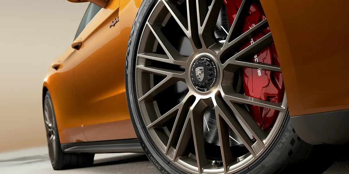 Porsche Panamera 4 E-Hybrid driving on the road with advanced suspension and hybrid performance.