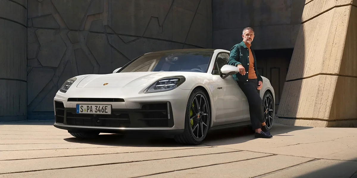 Porsche Panamera 4 E-Hybrid luxury plug-in hybrid sedan parked with modern architectural background.