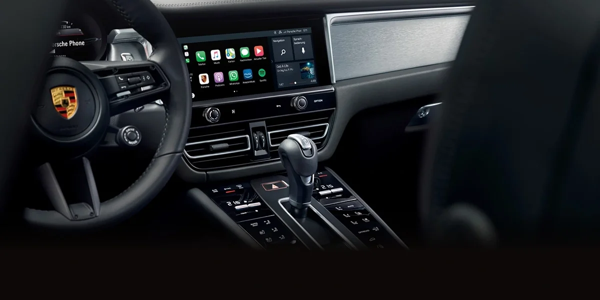 Porsche Macan interior featuring a driver-focused cockpit with digital displays, premium materials, and a modern dashboard design