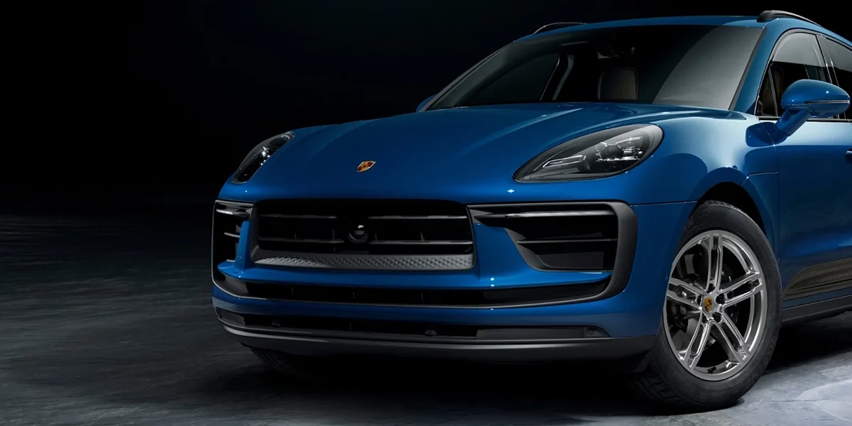  Porsche Macan parked in a modern setting, highlighting its sleek luxury compact SUV styling