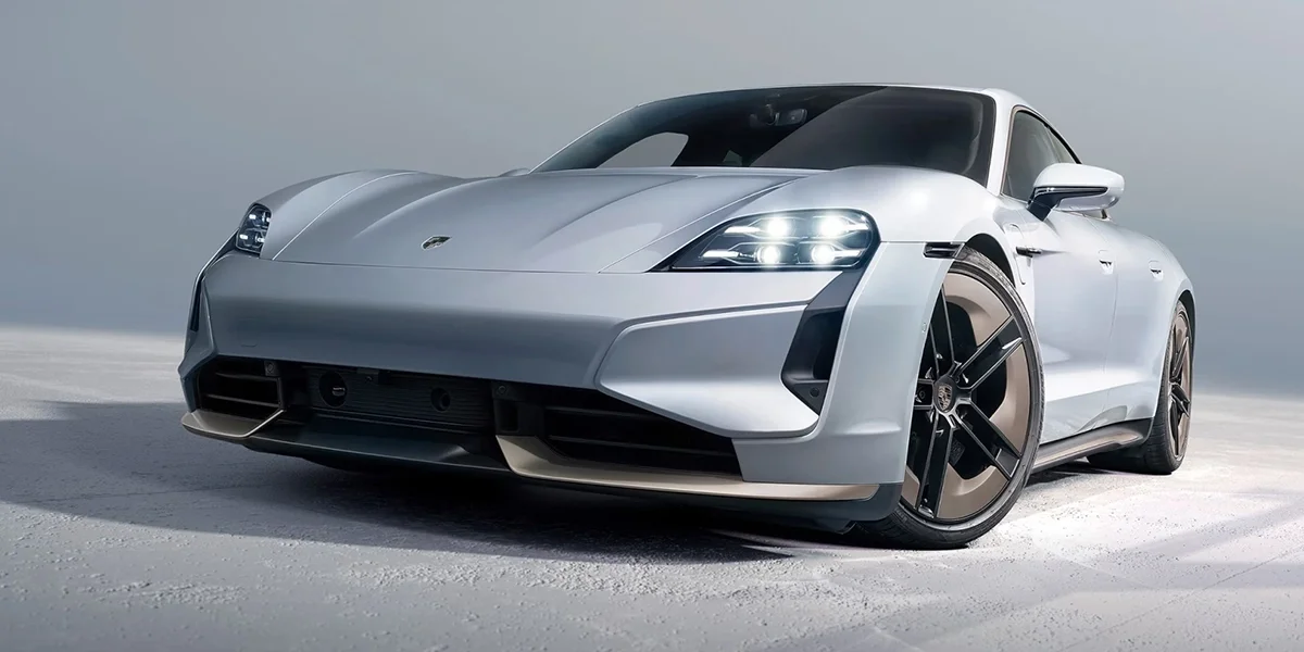 Porsche Taycan in silver, front three-quarter view with LED headlights.