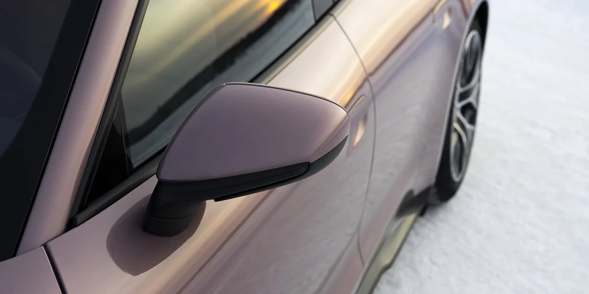Overhead top view of the Porsche Taycan, emphasizing clean aerodynamic design lines and panoramic roof.
