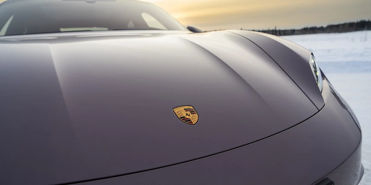 Porsche Taycan interior driver’s view with digital cockpit, multifunction steering wheel, and center display.