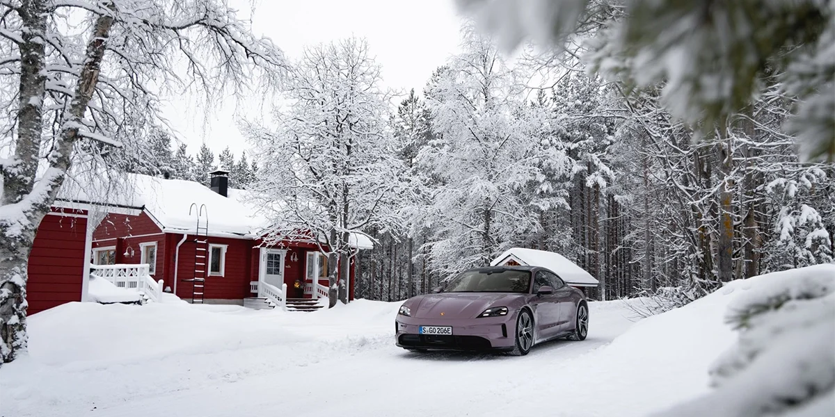 Porsche Taycan sliding across a snowy test track, demonstrating control and agility in winter conditions.