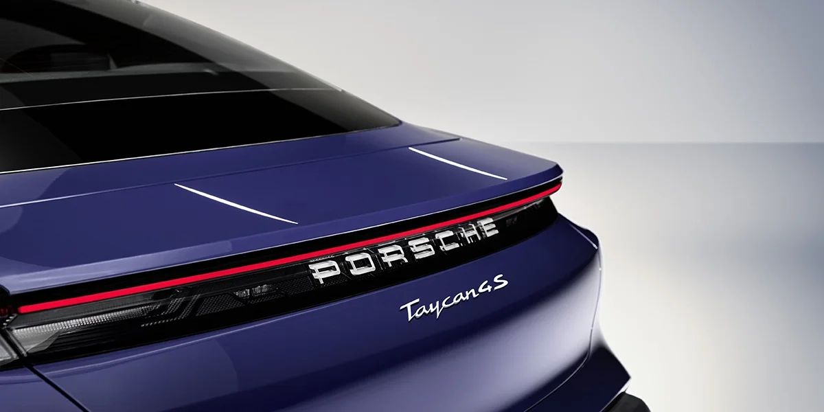 Porsche Taycan interior driver’s view with digital cockpit, multifunction steering wheel, and center display.