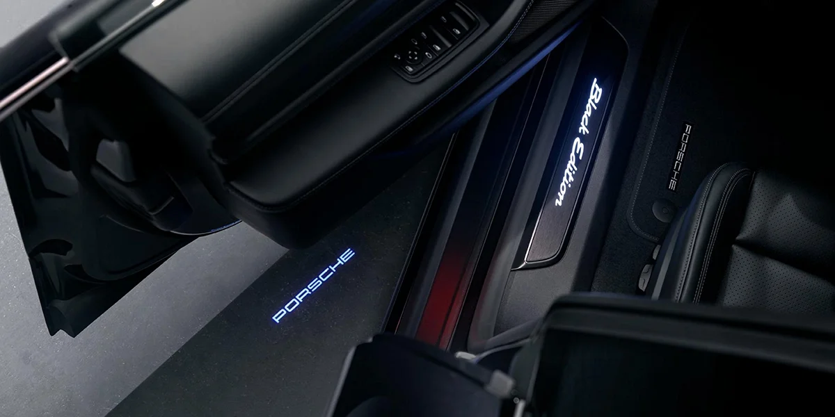 Porsche Taycan carving through snow, snow spray flying from rear wheels in a controlled drift.