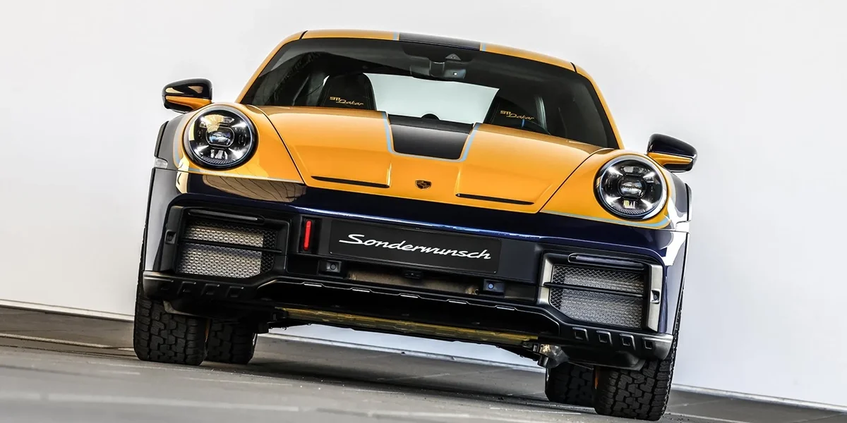 Front view of the Porsche 911 Dakar with lifted suspension, circular headlights, and off-road stance